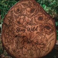 Wood burned "Stay Wild" floral design on lime round