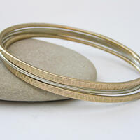 Anna K Baldwin Ellipse bangles in 9ct yellow and white gold
