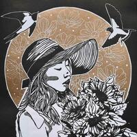 Summer Mistress is a black and white link print with a gold decoractive cirle behind the subject. The subject is a women wearing a sun hat and holding a bunch of sunflowers. The gold circle has summer floral detail. There are swallows flying overhead. 