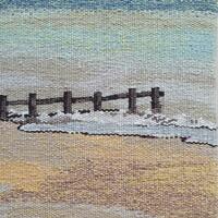 Tapestry showing a beach and sea, with a goin (sea fence) going out into the sea.