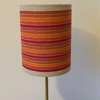 Lampshade made from handwoven fabric mounted on translucent backing.