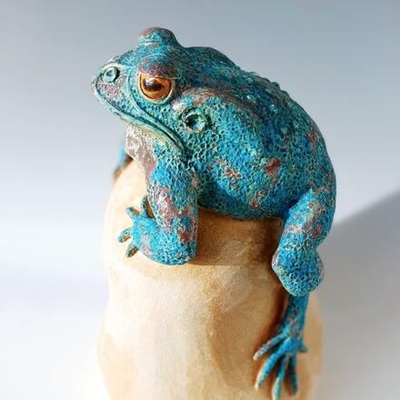 Decorative toad on boulder, height 45cms