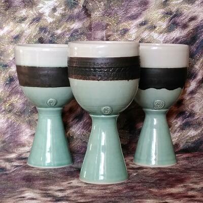 A set of 3 Goblets with green, bronze and white glaze