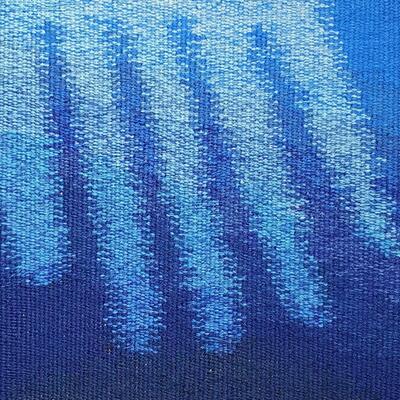 Tapestry weaving of fingers of light blue light reaching down into a dark blue watery background. Both the dark blue background and the light blue fingers of light graduate in tone from darker at the bottom to lighter at the top.