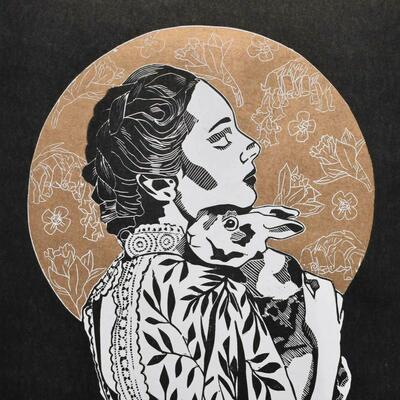 Spring Mistress is a black and white lino print with a gold circle background with spring floral details. The subject of the image is a women holding a rabbit.