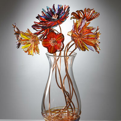Bespoke hand blown vases by Allister Malcolm, containing fused glass flowers on unique copper stems