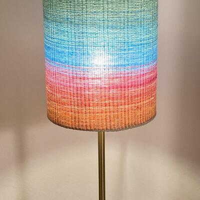 Lampshade made from handwoven fabric mounted on translucent backing.