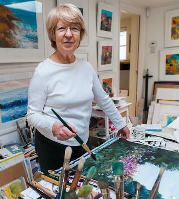 Mitzie Green in her studio painting acrylics