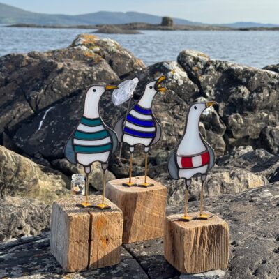 Purple Urchin Glass: Seagull characters, copper foiled stained and fused glass with wirework mounted on driftwood