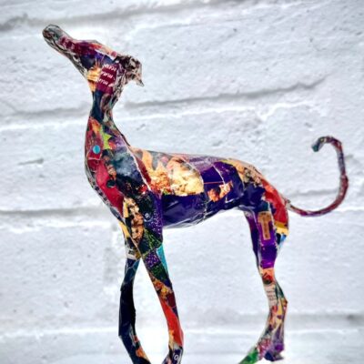 Lindsay Neale Waring - Sculptor: Now for something completely different. Stormalong Whippet is one of a series of Whippets i am currently working on. I was inspired by the passing of my mother last year. Carol Neale had been breeding, showing and judging Whippets for over 60 years and growing up with them has given me a real insight to their character. The medium of this sculpture is mixed. With a wire inner and papiere mache finish i have the freedom to go where that character takes me.  My intention is to mount these on a book, all about dogs. This one may not be available to purchase during Bucks Art Weeks but if you visit you will find out.