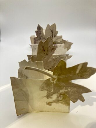 Folded book, eco printed with leaves on khadi rag paper. Fussy cut and folded to create a small sculptural book.
